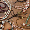 Garnet + pearl carved skull necklace