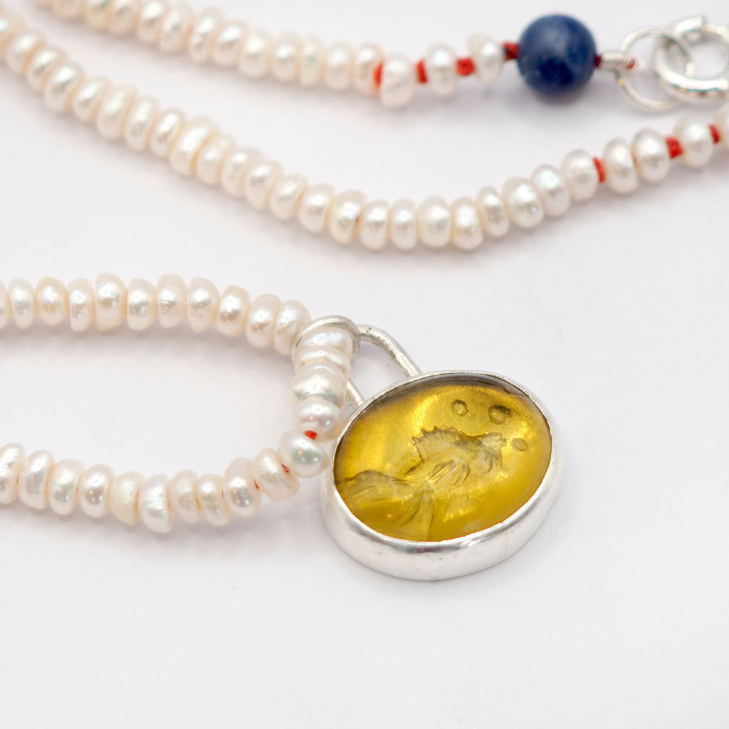 Amber fish intaglio and and pearl necklace