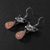 Peach moonstone cat vomit drop-earrings