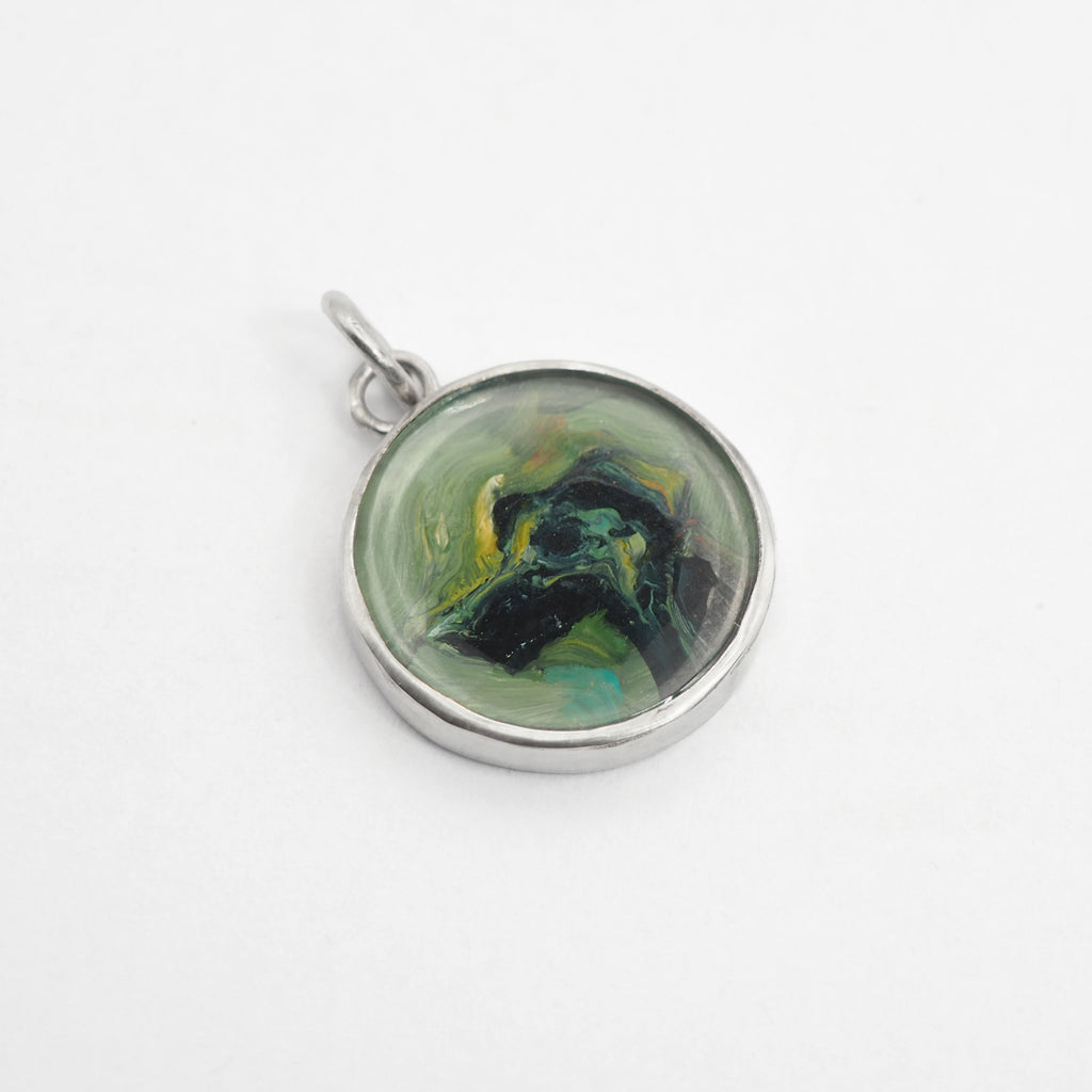 Hand-painted sterling silver pendant featuring a custom oil painting of a dog set beneath rock crystal.
