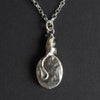 Field mouse intaglio necklace from the back, the solid silver reverse of the pendant with the mouse's long tail curling down and across it