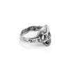 Angled view of the handcrafted sterling silver skull ring highlighting its low profile and sculpted shape.