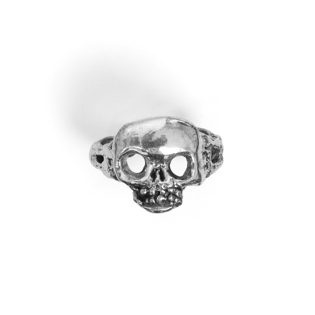 Front view of the handcrafted sterling silver skull ring, highlighting oxidized eye sockets, and textured teeth.