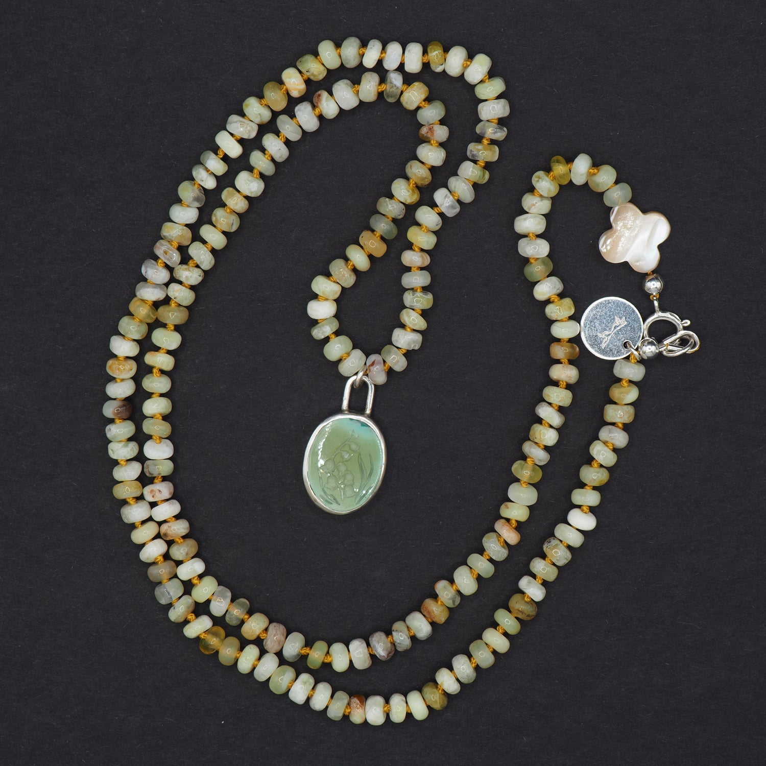 lily of the valley turquoise intaglio necklace - an unusual necklace, the oval seafoam turquoise pendant with its lily of the valley carving, coiled on hand-knotted Ethiopian opal beads