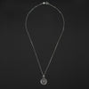 Pink Elephant reverse carved intaglio quartz necklace laid out full length on black, the clasp at the top and the round quartz pendant at the foot of the chain
