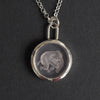 Pink Elephant reverse carved intaglio quartz necklace - an unusual necklace, an elephant caught mid-air, reverse-carved into a disc of the palest pink quartz above tufts of grass