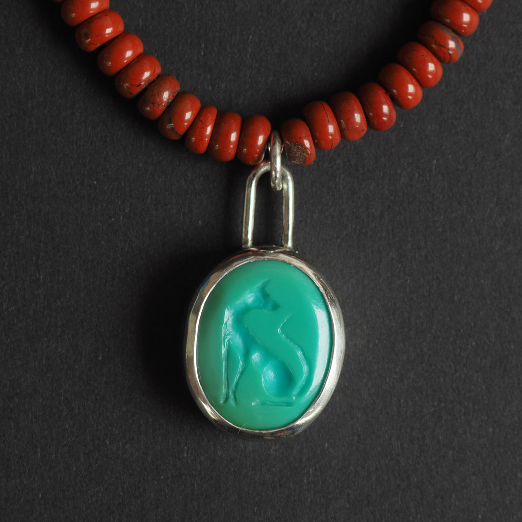 turquoise intaglio cat necklace on red jasper - a cat necklace, a stylised cat seated in profile with its tail curled, hand-carved into a green turquoise oval