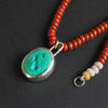 turquoise intaglio cat necklace on red jasper with the clasp end alongside, the crazy lace agate accent beads in cream and honey beside the bolt ring