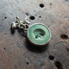 Hollow-eyed skull turquoise intaglio charm