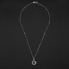 The End Quartz reverse intaglio necklace laid out full length on black, the bolt-ring clasp at the top and the small crystal disc at the foot