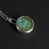 Turquoise Skeletal Torso intaglio necklace - a skeleton necklace, a skull and ribcage cut deep into a round slice of Tibetan turquoise, the bones seeming to slump and run