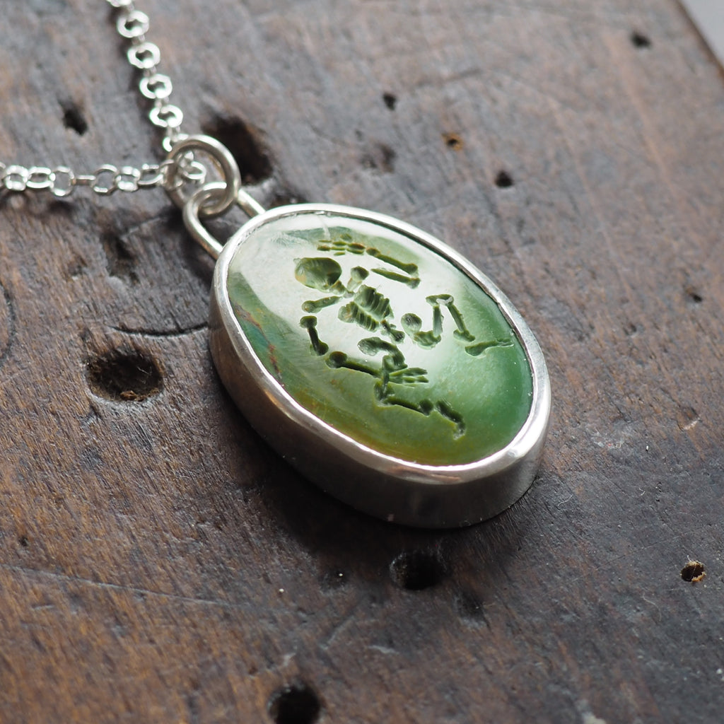 Turquoise skeleton intaglio necklace