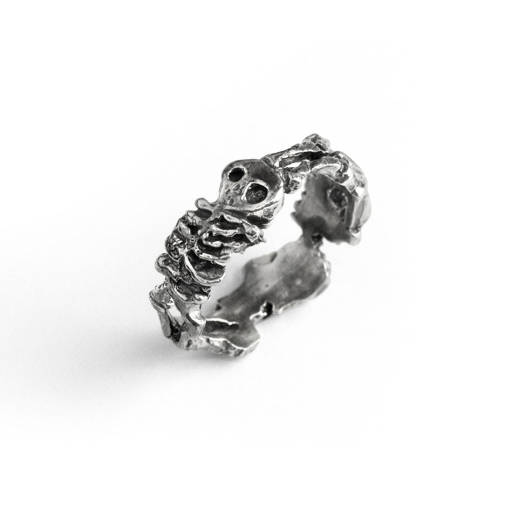 Close-up view of the sterling silver skeleton ring showing detailed ribs and oxidised bone texture